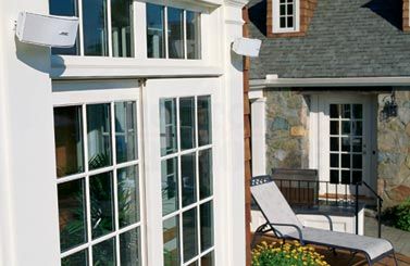 Outdoor Bose speakers above French doors